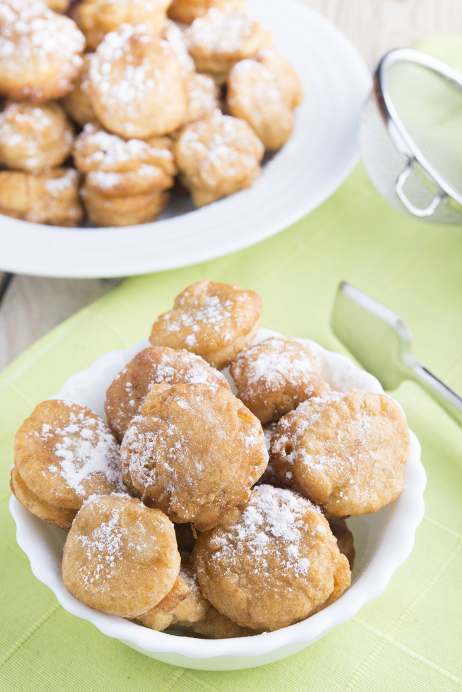 a batch of christmas dessert cookies on a green tablecloth